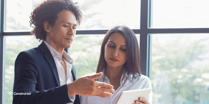 Man and woman looking at tablet screen